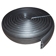 A black rubber cable floor cover protector